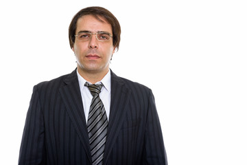 Studio shot of young Persian businessman wearing eyeglasses