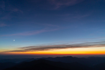The picturesque sunrise above mountains. evening night time
