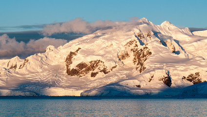Sunset light on snow-capped mountains and glaciers, Antarctic Peninsula
