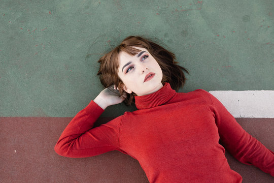 Young woman lying on rubber ground
