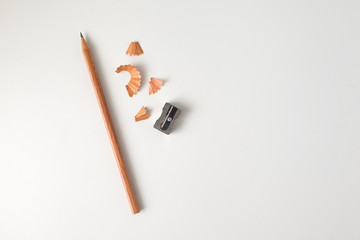 Wood pencil with sharpener isolated on white desk background