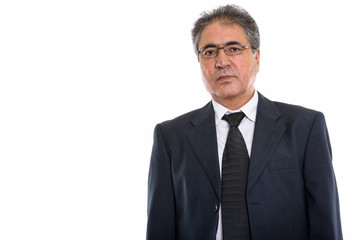 Studio shot of senior Persian businessman wearing eyeglasses