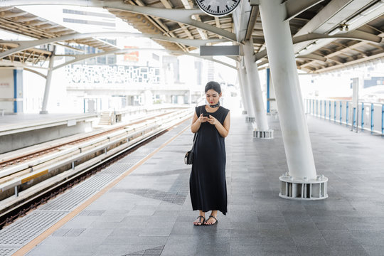 Woman Waiting on Train Station