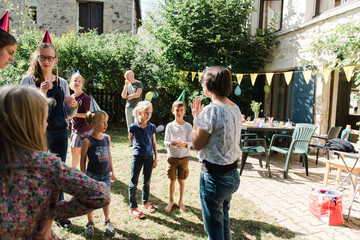 mom explaining game at birthday party