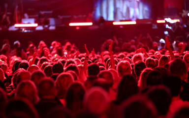 red lights on the heads of people during a concert