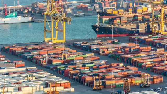 Large cargo port in Barcelona. Cranes and containers. Aerial view. Time lapse video. 