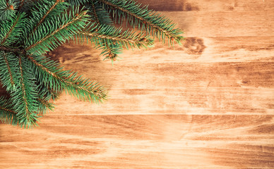 christmas wooden background with fir branches and balls