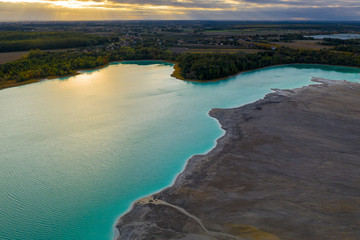 Turquoise water of lake powered by power plant mineral waste. Aerial view.