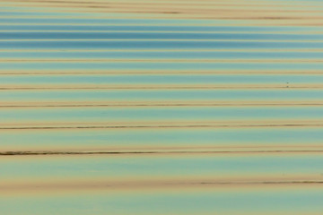 The surface of the water in the pond at sunset as a background