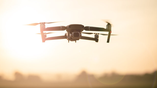 Drone like Mavic 2 Pro flying during sunset.
