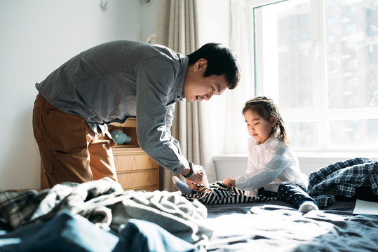 Asian Family Folding Laundry At Home