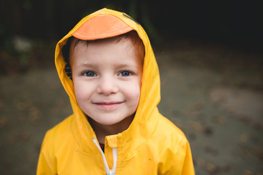 Portrait of smiling boy in yellow raincoat