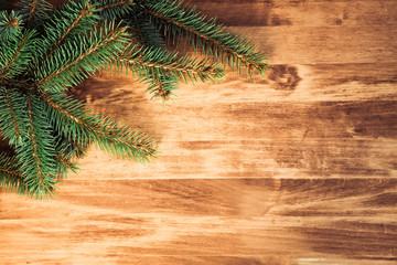 christmas wooden background with fir branches and balls
