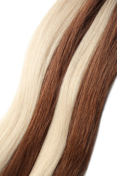 Strands of different color hair on white background