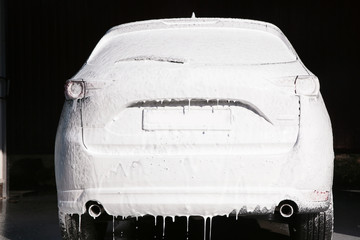 Automobile covered with foam at car wash