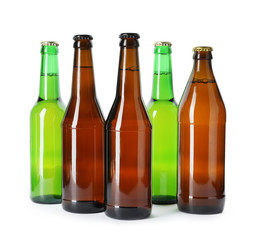 Bottles with different alcoholic drinks on white background