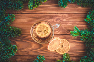 Festive table for the new year and Christmas with a Christmas tree, an orange and gifts
