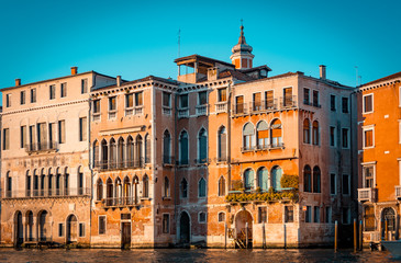 Ancient palaces in Venice Italy. Orange and teal mood.