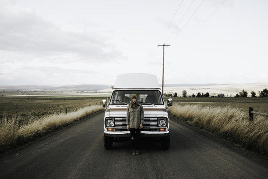 Fototapeta Girl standing in front of van