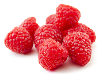 Vegetarian diet, summer raspberry fruits and healthy nutrition concept with close up on a pile of raspberries isolated on white background