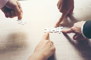 team hand power full placing the  jigsaw puzzle piece for conect business partner and connection...