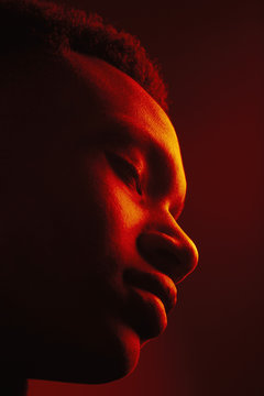 African American man portrait under red lights