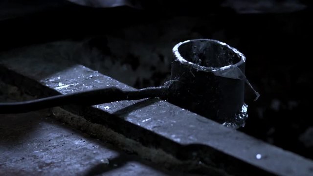 Blacksmith Puts Ladle With Remnants Of Hot Metal