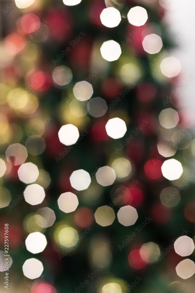 Wall mural new year's background a bokeh from sparks illumination on a fir-tree