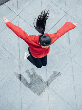 Asian Teenage Girl With Jumping In Rainy Day