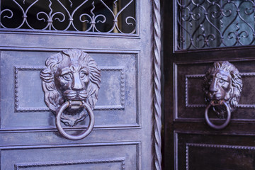 Exterior vintage door knocker metal circle on a door of an ancient building in Catania, Sicily, Italy