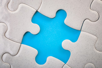 Teamwork, completing the final task and finding the solution concept with pieces of jigsaw puzzle...