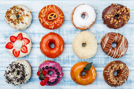 Donuts In assortment, on old wood background. Top view. Space for text.