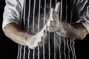 Chef claps flour covered hands