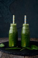Green vitamin smoothie from spinach in a bottle