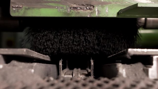 Conveyor Chain Moving Under Brush On Old Equipment