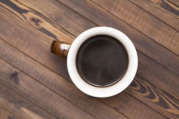 Cup of coffee  on wooden background, the view from the top