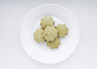 Homemade biscuits on a white plate.