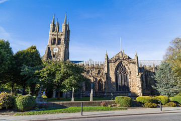 The church of St John the Baptist in Tideswell, Derbyshire seen during under a blue sky in the...