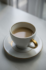 Morning coffee on the table near window