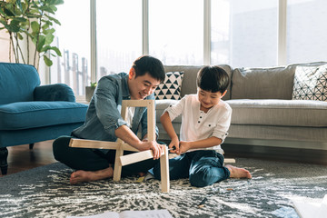 Father and son working on carpentry at home