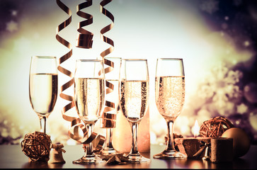 champagne glasses against holiday lights ready for New Year's eve party