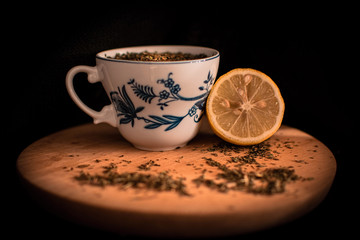 Mint tea with lemon on black background
