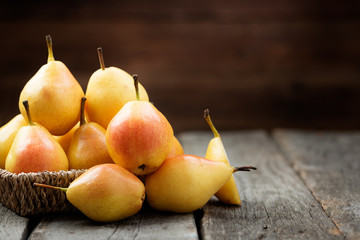 Fresh pears  in a box on wooden table.