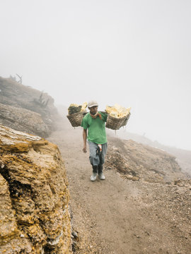 Man carrying sulfur extractions in mist