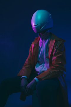 Futuristic person /anonymous with white helmet/mask iluminated with neon light.
