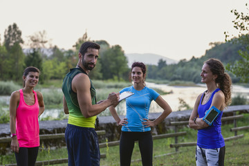  male trainer talking to group of athlete