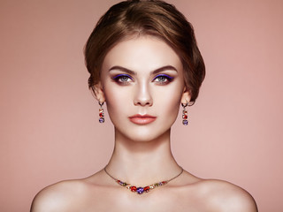 Portrait Beautiful Woman with Jewelry. Fashion Makeup and Cosmetics. Elegant Hairstyle. Violet Make-up Arrows. Beauty and Accessories
