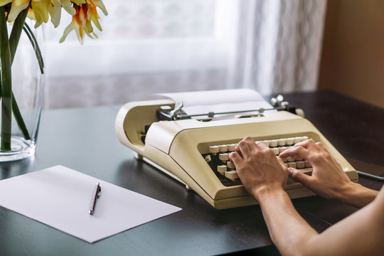 Woman typing on a typewriter