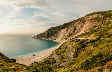 Postcard Kefalonian view on Myrthos beach and serpentine road shoot at golden hour. Ionian islands,...