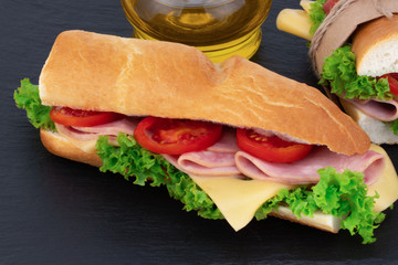 sandwich with  with ham, cheese, tomatoes, lettuce on  over stone. Top view with copy space